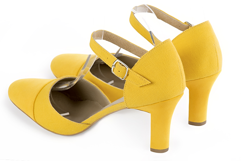 Yellow women's open side shoes, with an instep strap. Round toe. High kitten heels. Rear view - Florence KOOIJMAN